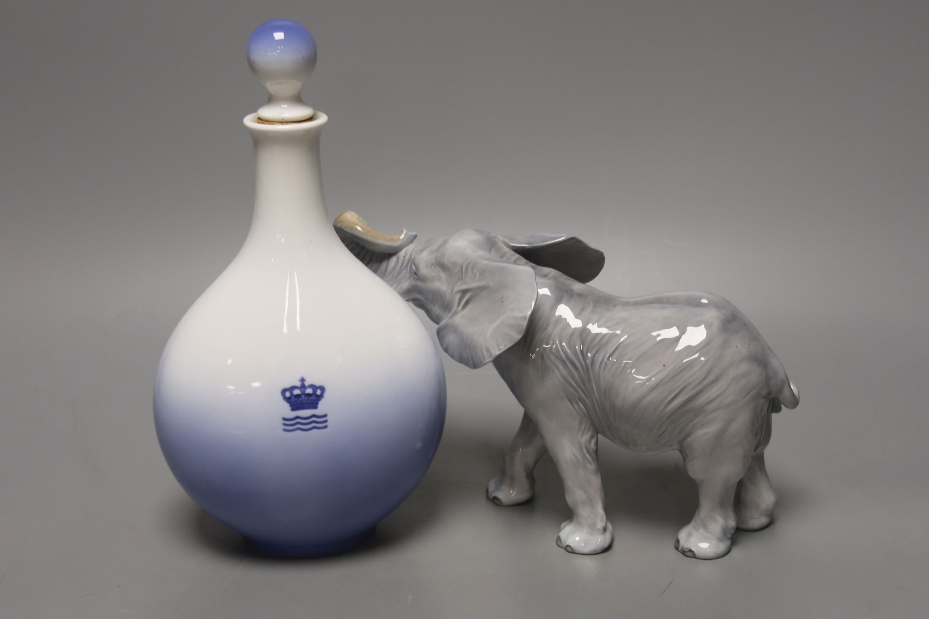 A Royal Copenhagen bottle and stopper and a model of an elephant, bottle and stopper 25 cms high.